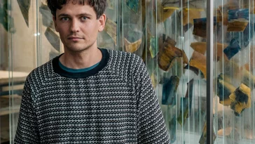 a man standing in front of a store window