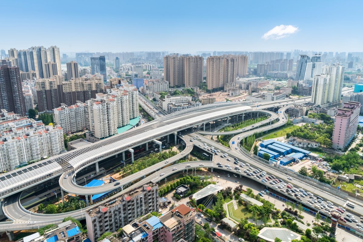 aerial view of city interchange overpass with blue sky, beautiful wuhan cityscape with urban traffic development, china