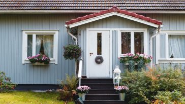 fragment of wooden finnish blue house with decorated entrance. rural scene, country lifestyle.