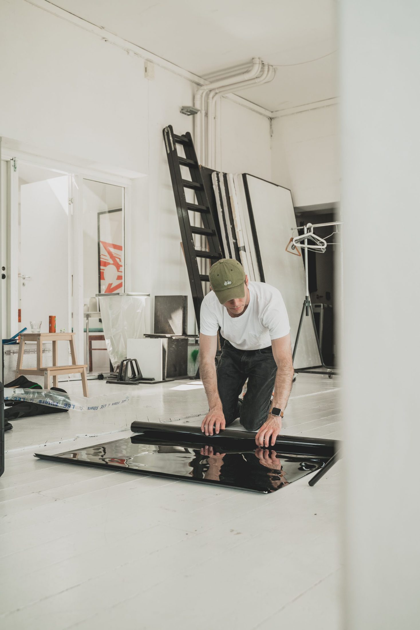 man in white t-shirt and black pants standing on exercise equipment