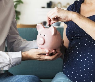 family saving money in piggy bank