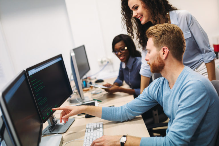 young software engineers working on project and programming in company