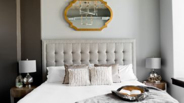 tufted white bed near window