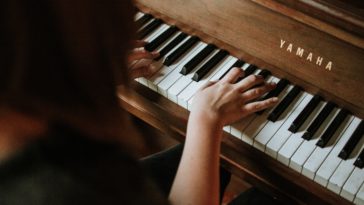 woman playing yamaha piano