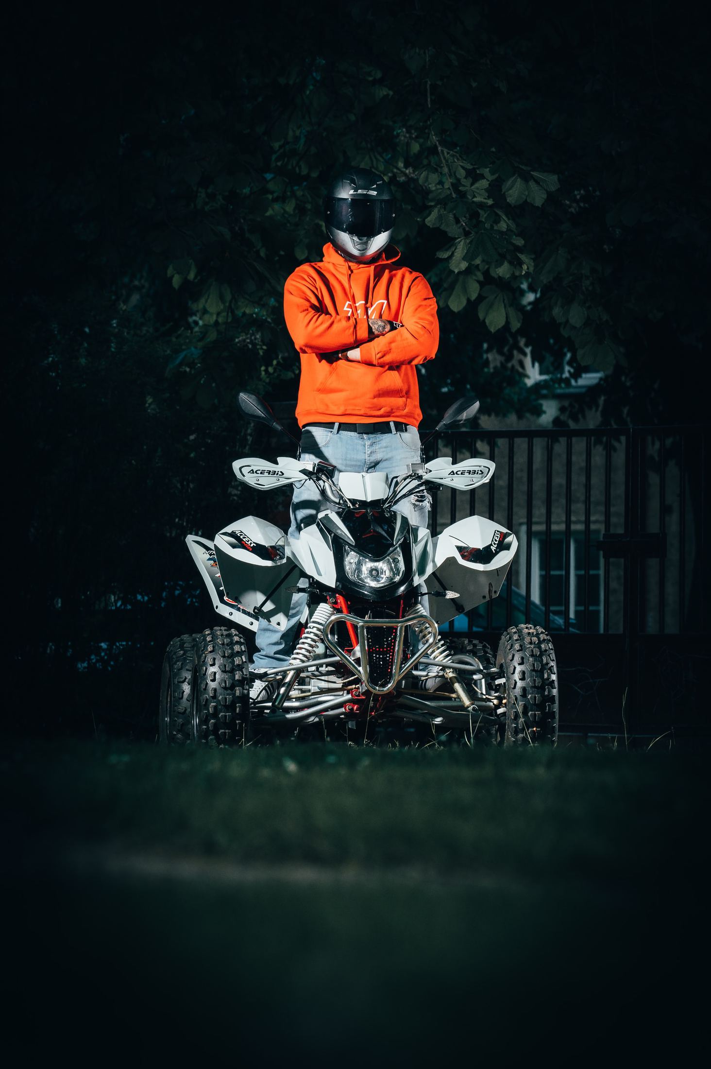 man in orange jacket riding white and black motorcycle