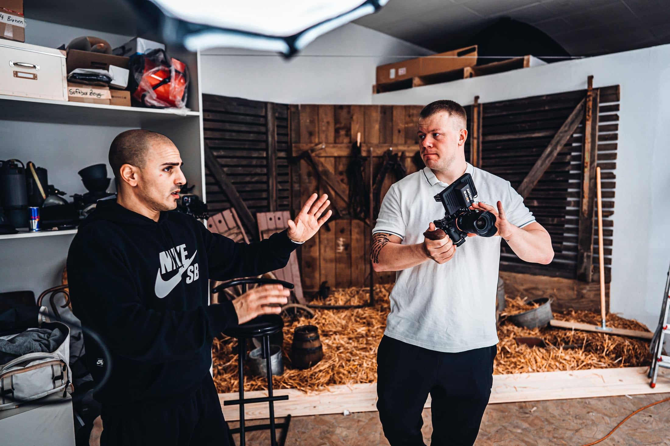 man in black and white crew neck t-shirt holding black dslr camera