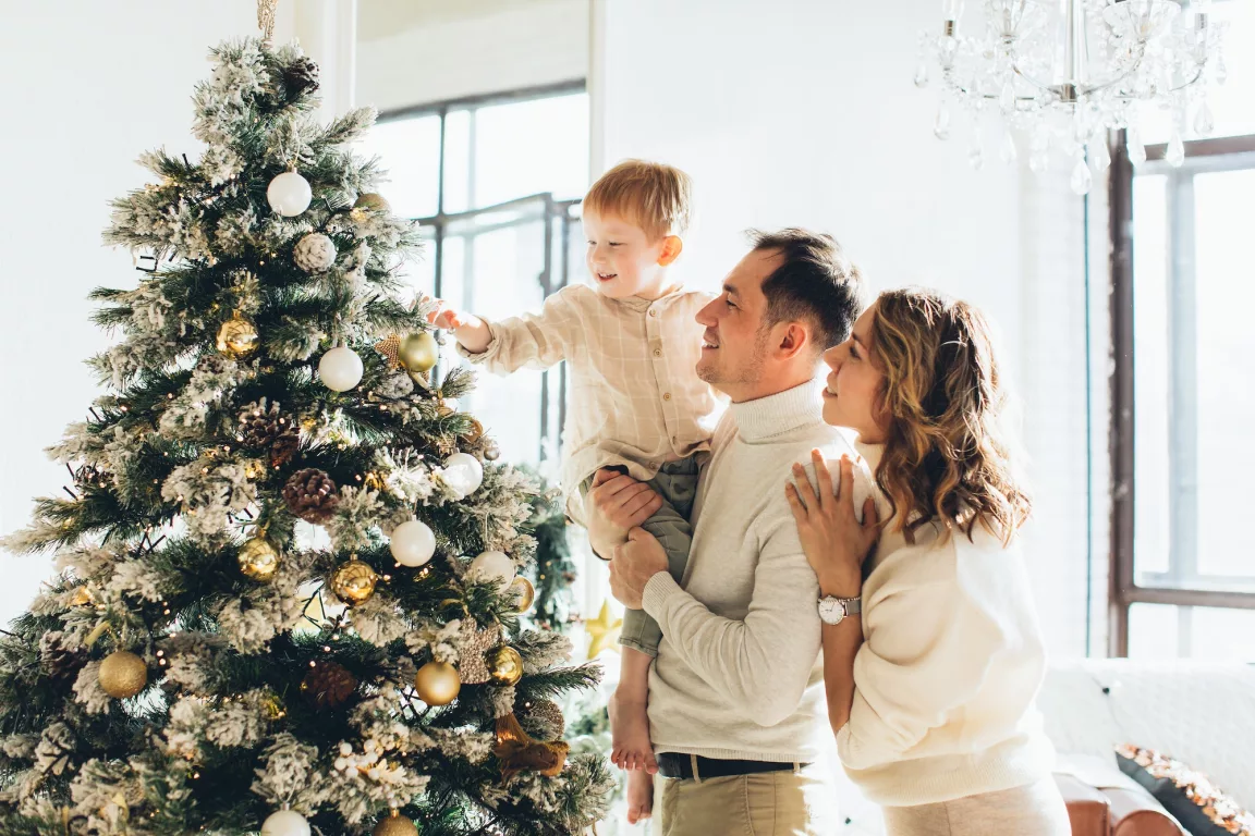 couple with their son looking at a christmas tree