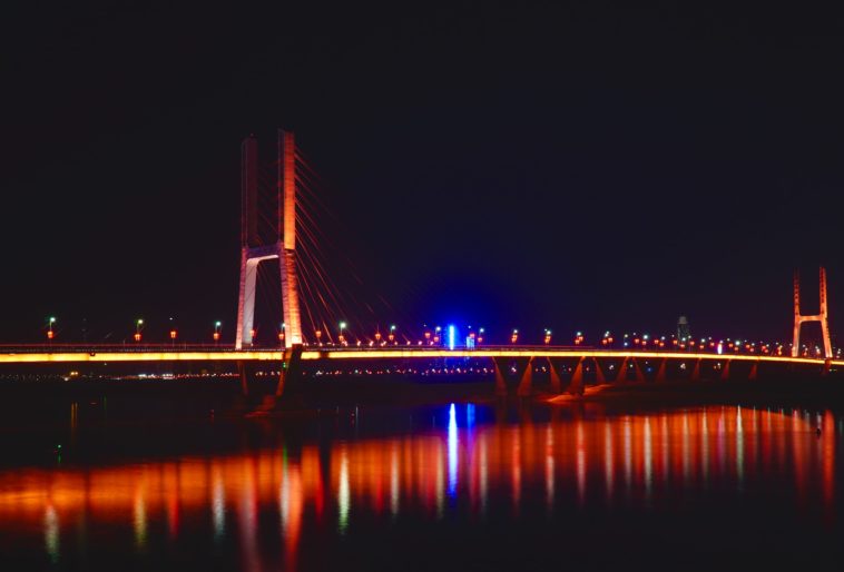 a large bridge lit up at night