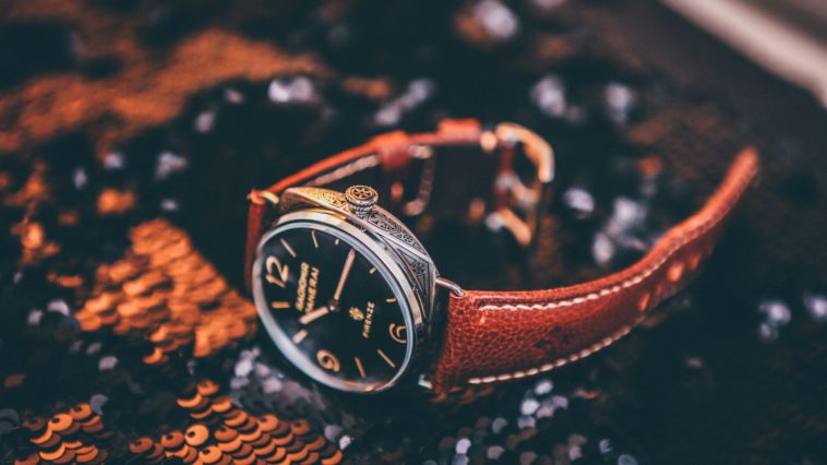 round silver-colored analog watch with brown leather strap