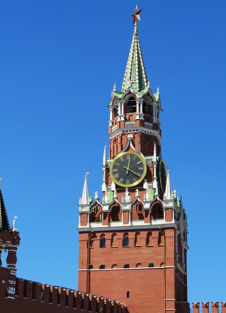 a large tall tower with a clock at the top of moscow kremlin