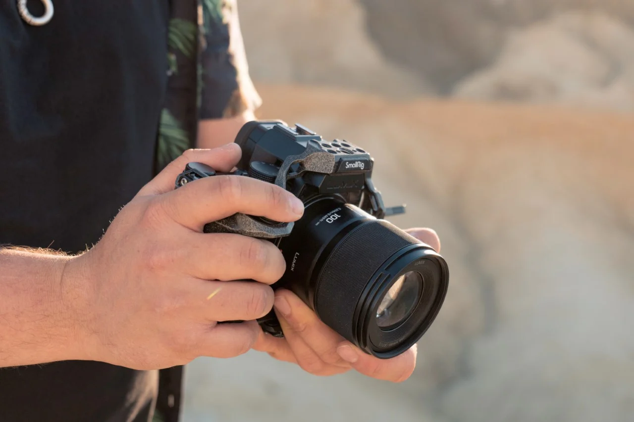 a close up of a person holding a camera