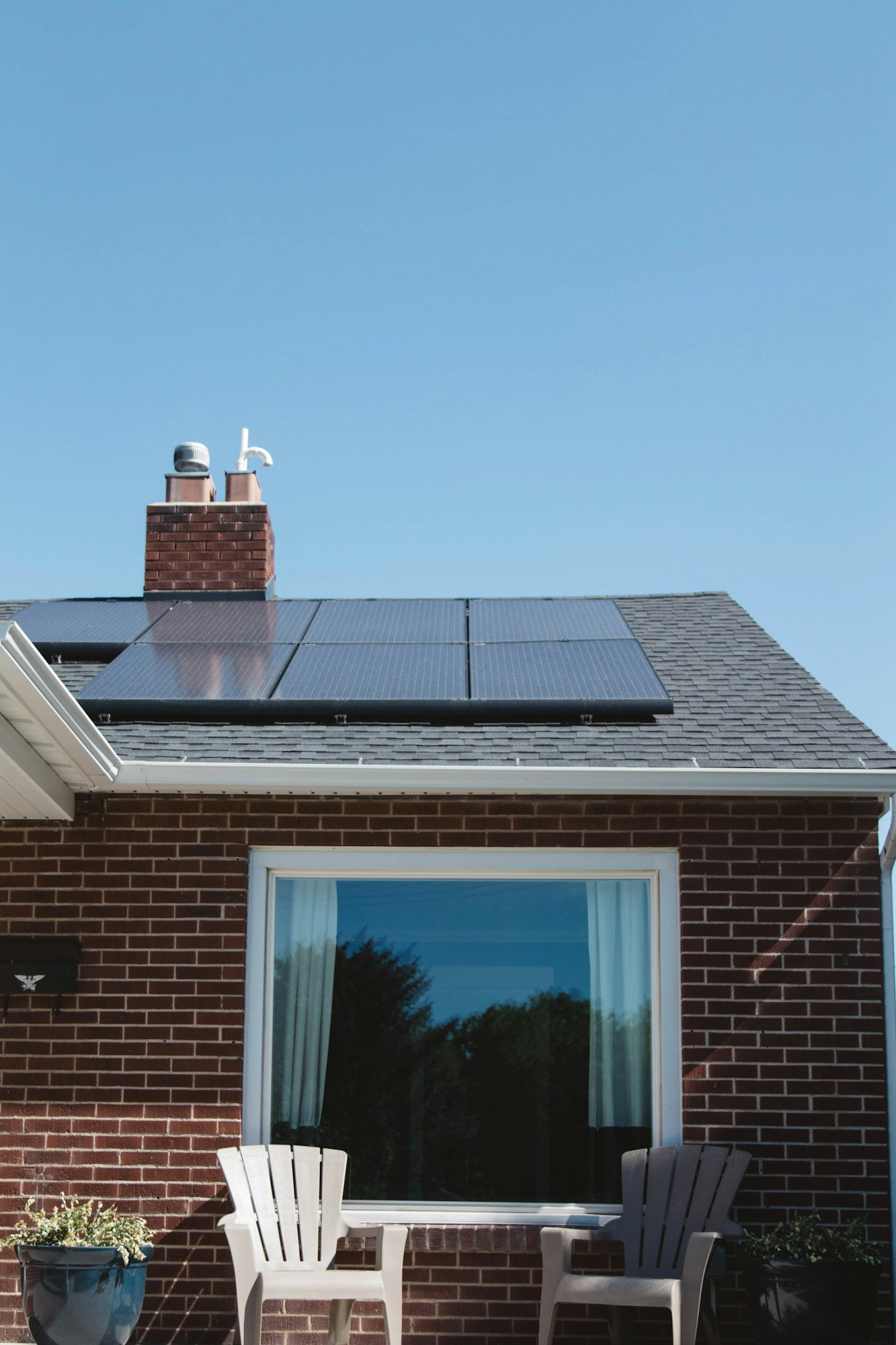 Eco-Friendly Home: 3 Best Sustainable Energy Options brown brick house with solar panels on roof