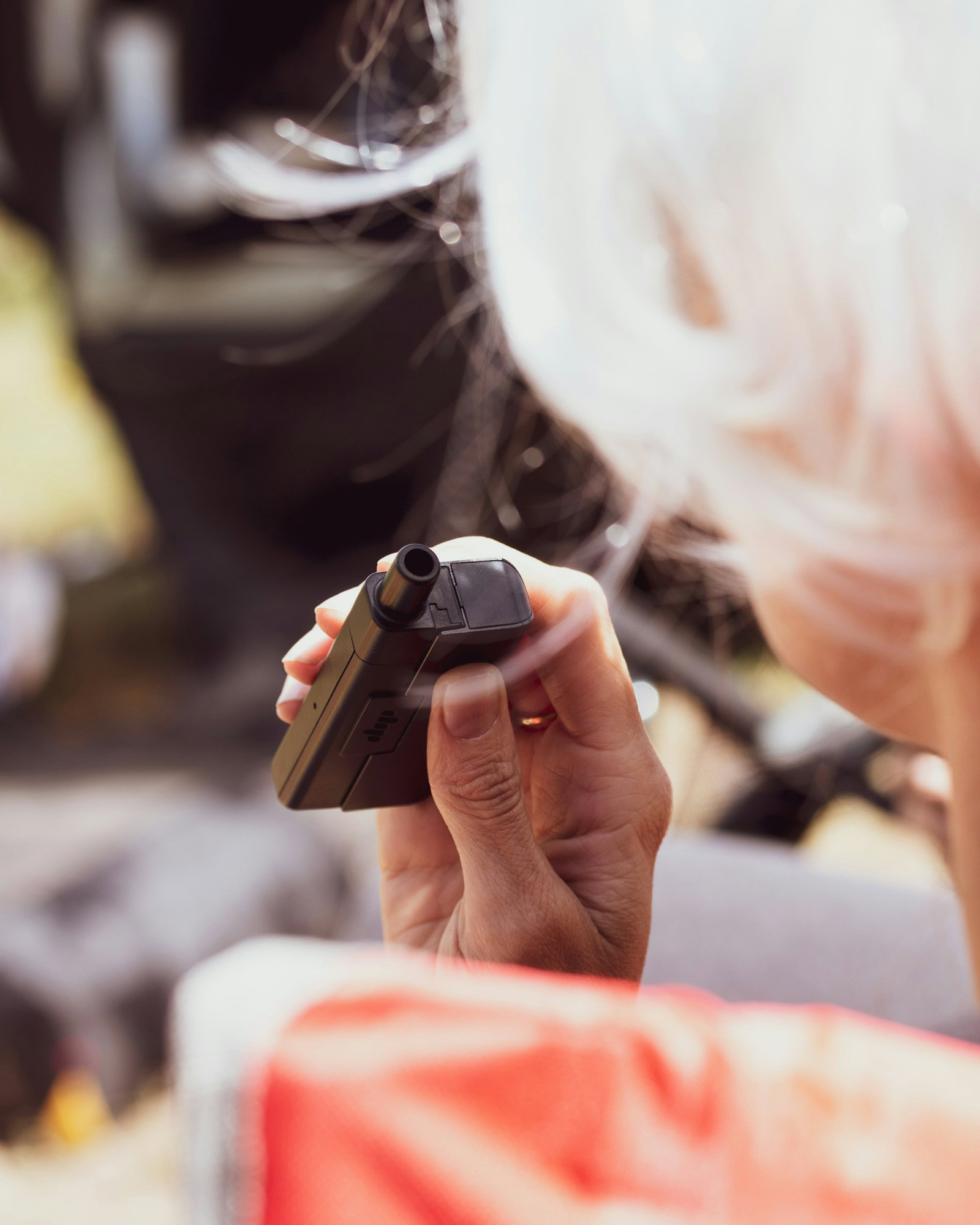 Exploring the World with Ease: How Portable Vaporizers Enhance Travel Experiences a person holding a remote control