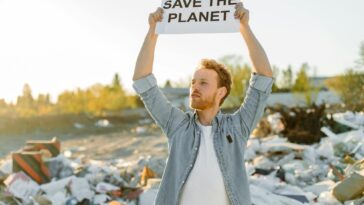 man advocating for environmental conservation amidst a landfill.