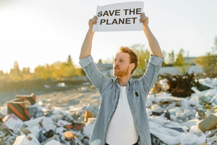 man advocating for environmental conservation amidst a landfill.