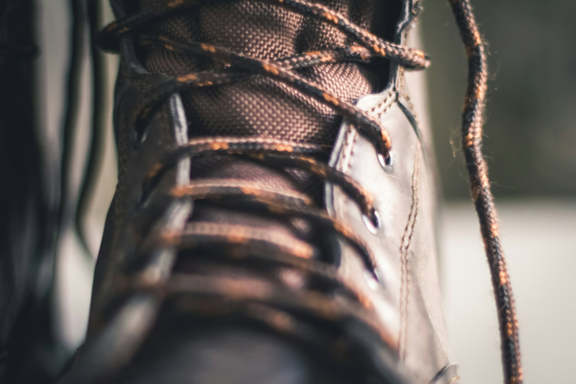 The Business Case for Choosing American-Made Work Boots person wearing brown and black hiking shoe