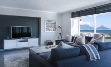 a living room with a large window overlooking the ocean description automatically generated
